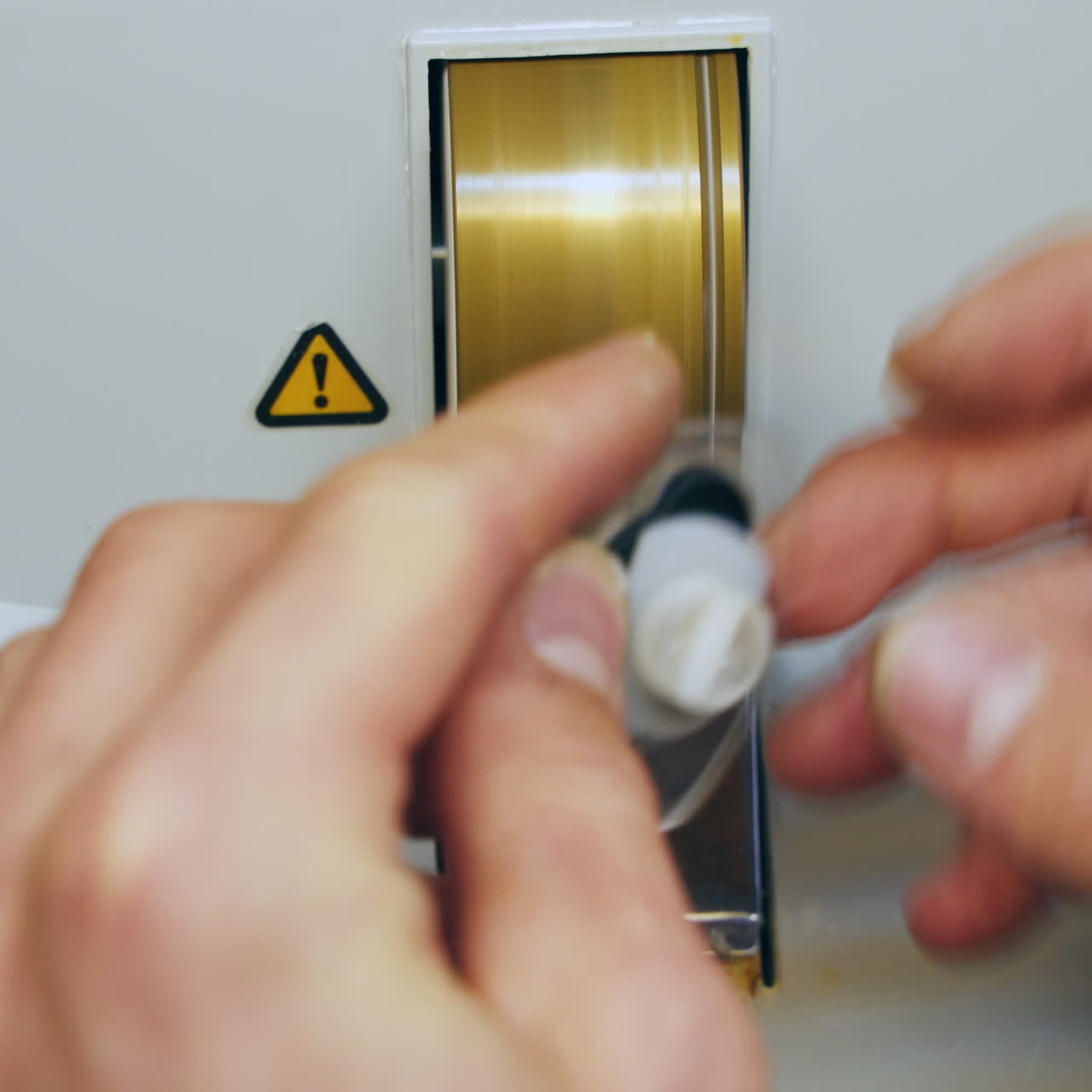 Manufacture of lenses for glasses. Close-up hands of optician making lense for eyeglasses on a special instrument. Close-up.