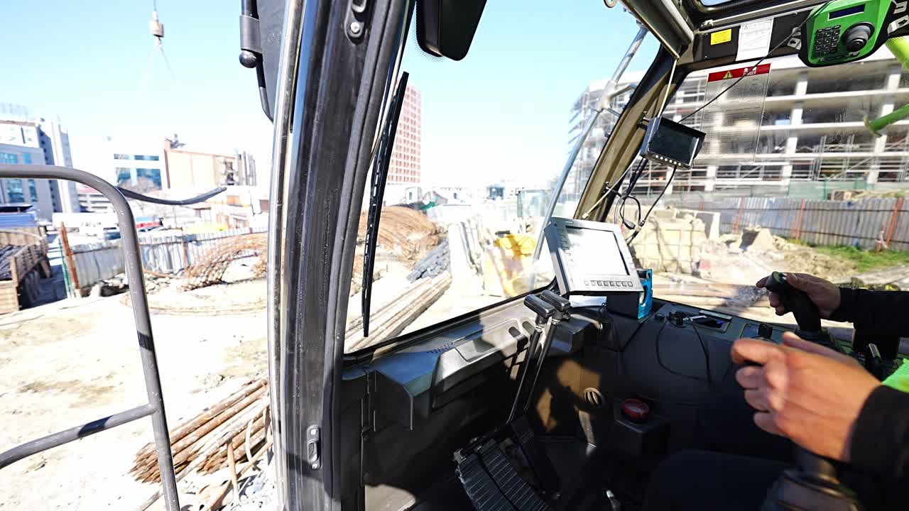 crane operator at construction site commands truck to move rebar to another area