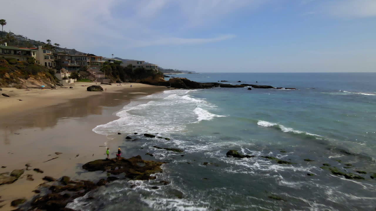 Scenic Beach with Waves and Coastal Homes