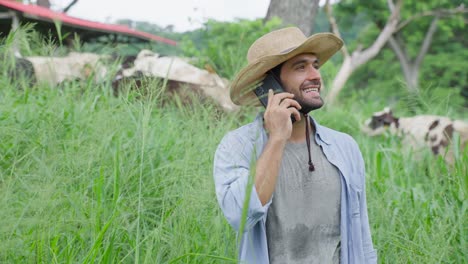 farmer talking on phone on farm