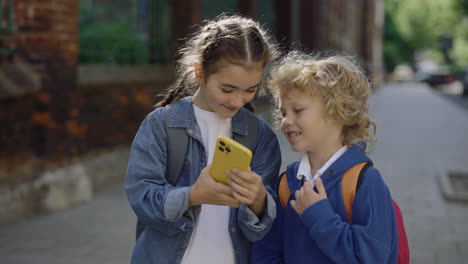 children looking at a smartphone