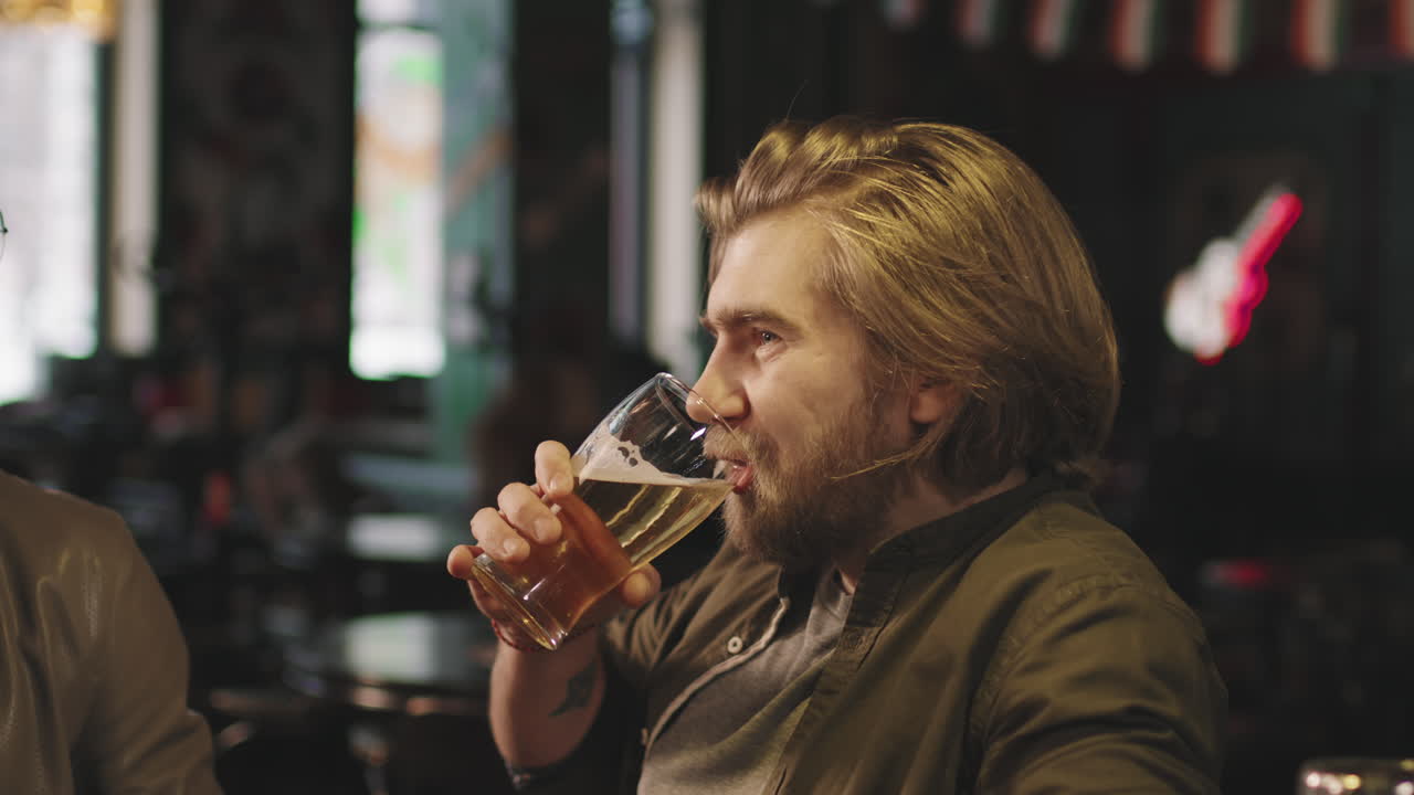 Bearded Man With Beer Talking In Bar
