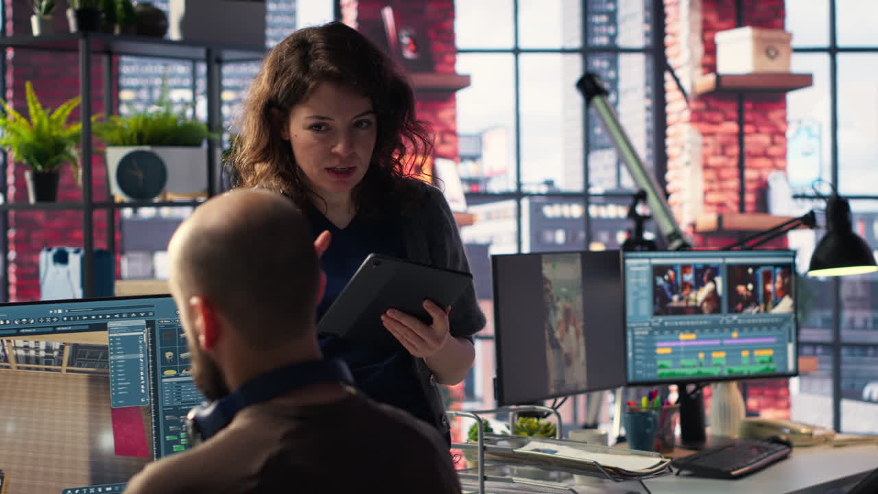 Architectural design team configures a floor plan on dual monitors