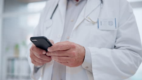 Hands,-smartphone-and-doctor-typing-in-hospital