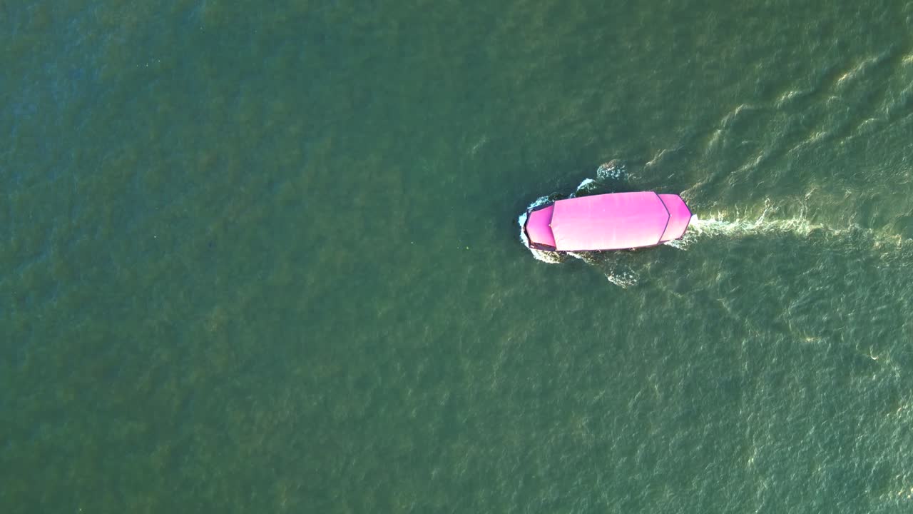 Chao Phraya River flowing through Bangkok, Thailand, at sunset. Majestic aerial view flight vertical bird's eye view drone