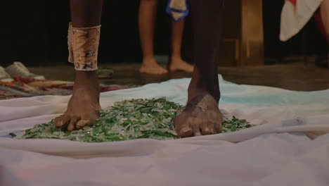 yogi man stepping on broken glass