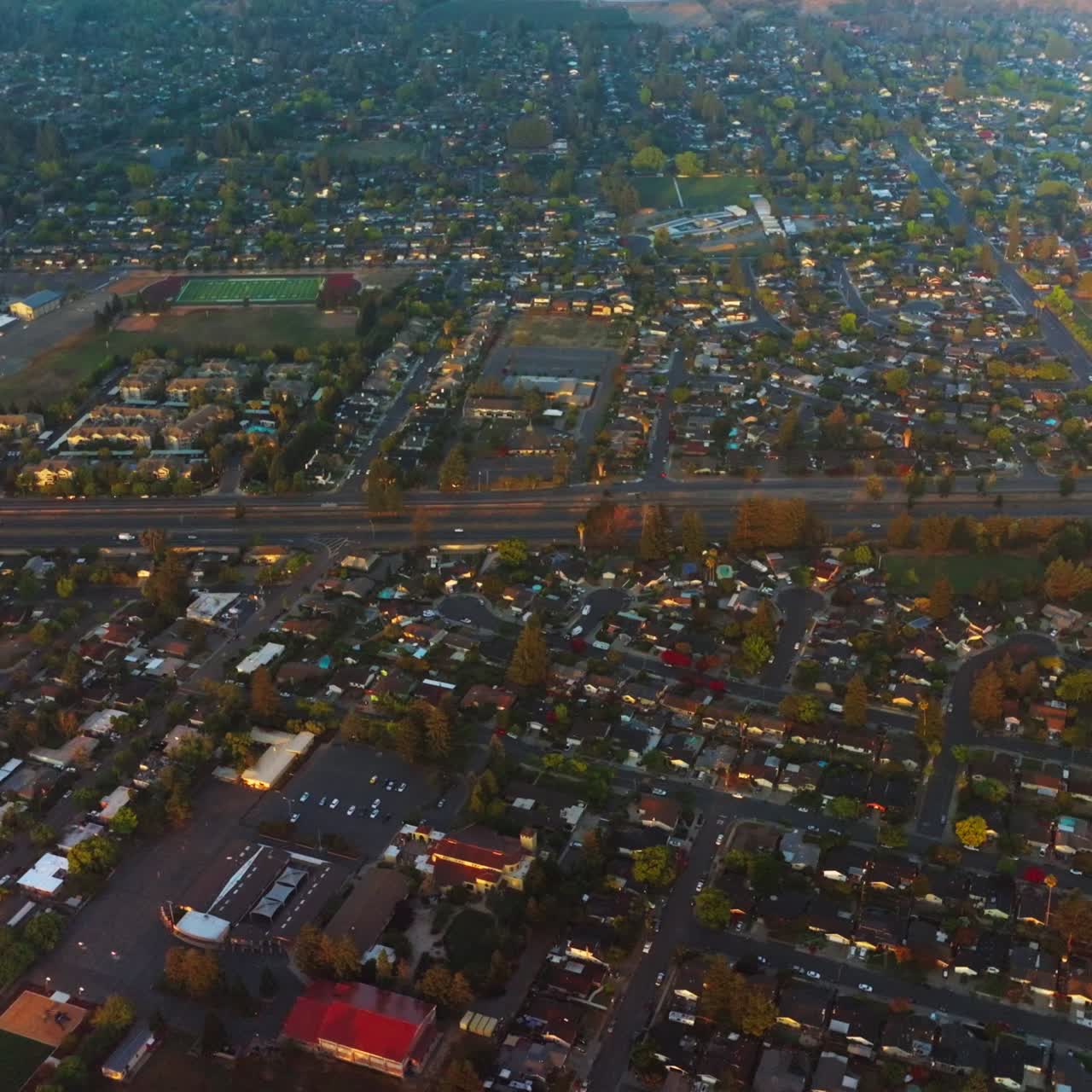 Urban panorama of densely built city. Napa, California, USA crossed by roads from aerial perspective at daytime