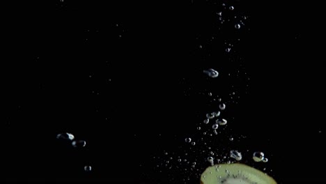 kiwi falling into water super slowmotion, black background, lots of air bubbles, 4k240fps