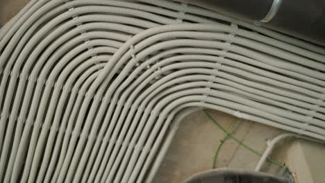 electrical conduit and ventilation pipe on concrete ceiling