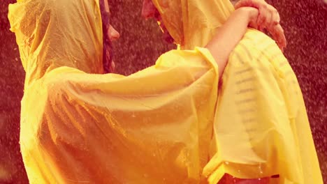 happy couple hugging in the park during rain