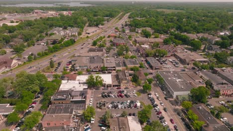 drone shot of a vibrant downtown area in a quaint small town, capturing the lively atmosphere and bustling streets