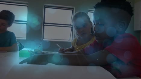 blue spots of light against diverse boy and girl studying together in the class at school