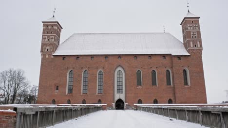 snow covered pathway and structure facade of lidzbark bishops' castle in lidzbark county, poland near hotel krasicki