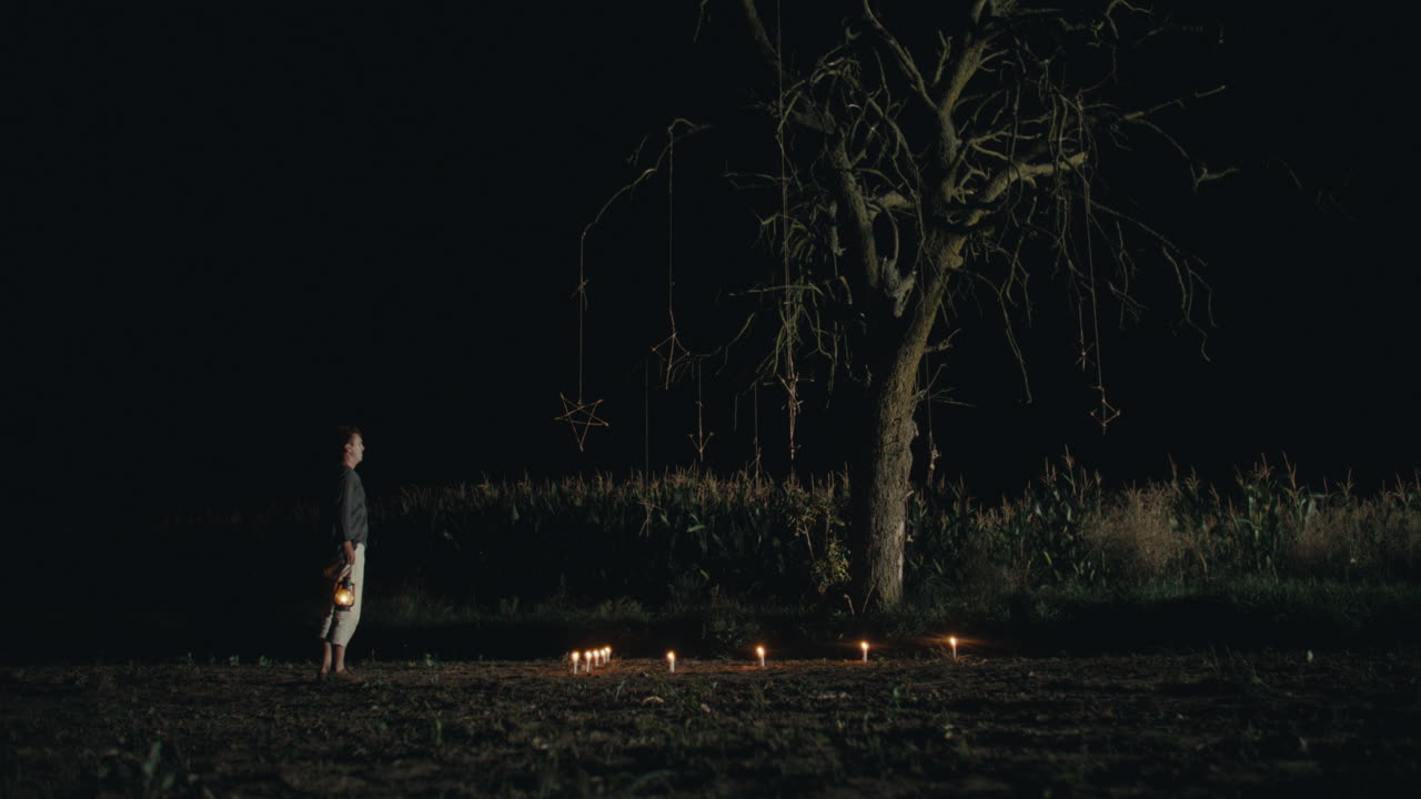 A Solitary Night Ritual Under a Bare Tree