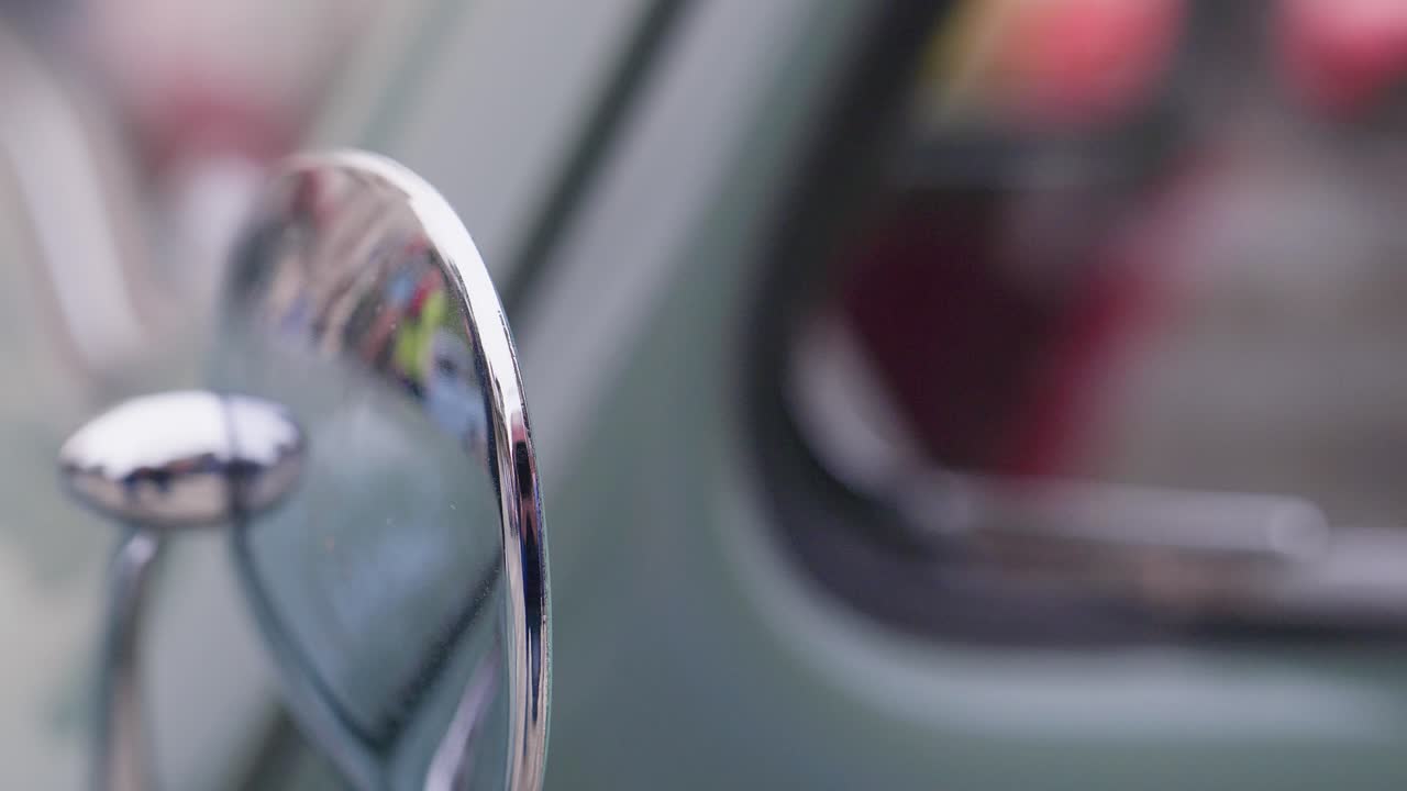German Classic 'Beetle' car chrome wing mirror CLOSE-Up shot hand held