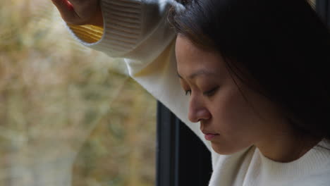 Close-Up-Of-Stressed-Or-Anxious-Woman-Suffering-With-Depression-Anxiety-Loneliness-Or-Agoraphobia-Leaning-Against-Window-At-Home-2