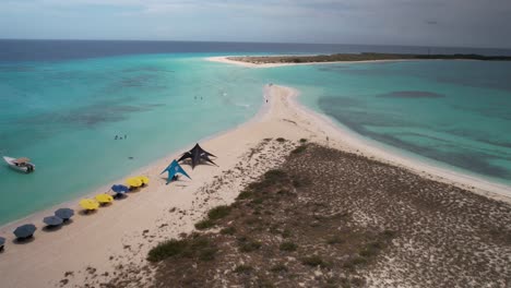 aerial view of a stunning tropical sandbar with clear turquoise waters and beach activities