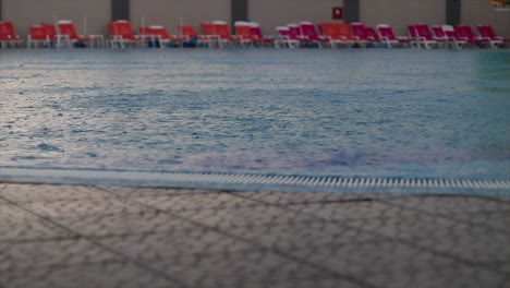 rain falling in an empty public swimming pool