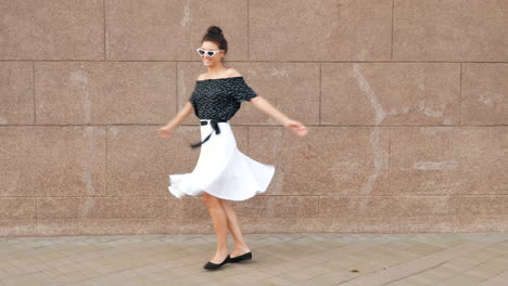 stylish woman dancing on the street