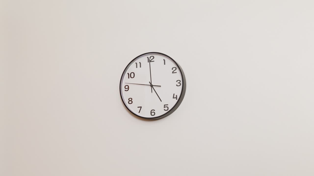 A timekeeping essential—this office clock in a wide shot displays 5:00, ideal for illustrating productivity, work schedules, and punctuality.