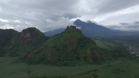 Wide-shot-countryside-of-Guatemala-with-fuego-and-Acatenango-in-background,-aerial