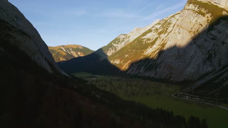 alps valley mountain peaks in austria tyrol with romantic and scenic green grass meadows and maple trees in natural landscape