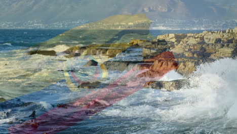 composición digital de ondear la bandera de ecuador contra las olas del mar que golpean las rocas