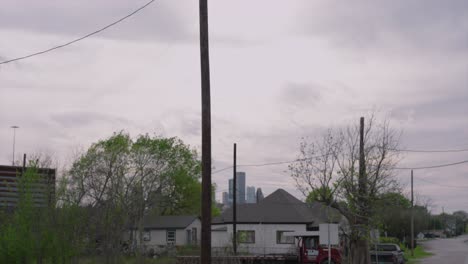 view of railroad crossing in foreground and houston neighborhood in background