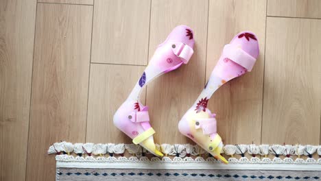 colorful childrens leg braces on wooden floor