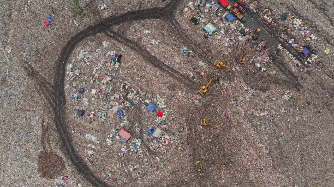Bulldozers working in huge landfill aerial view