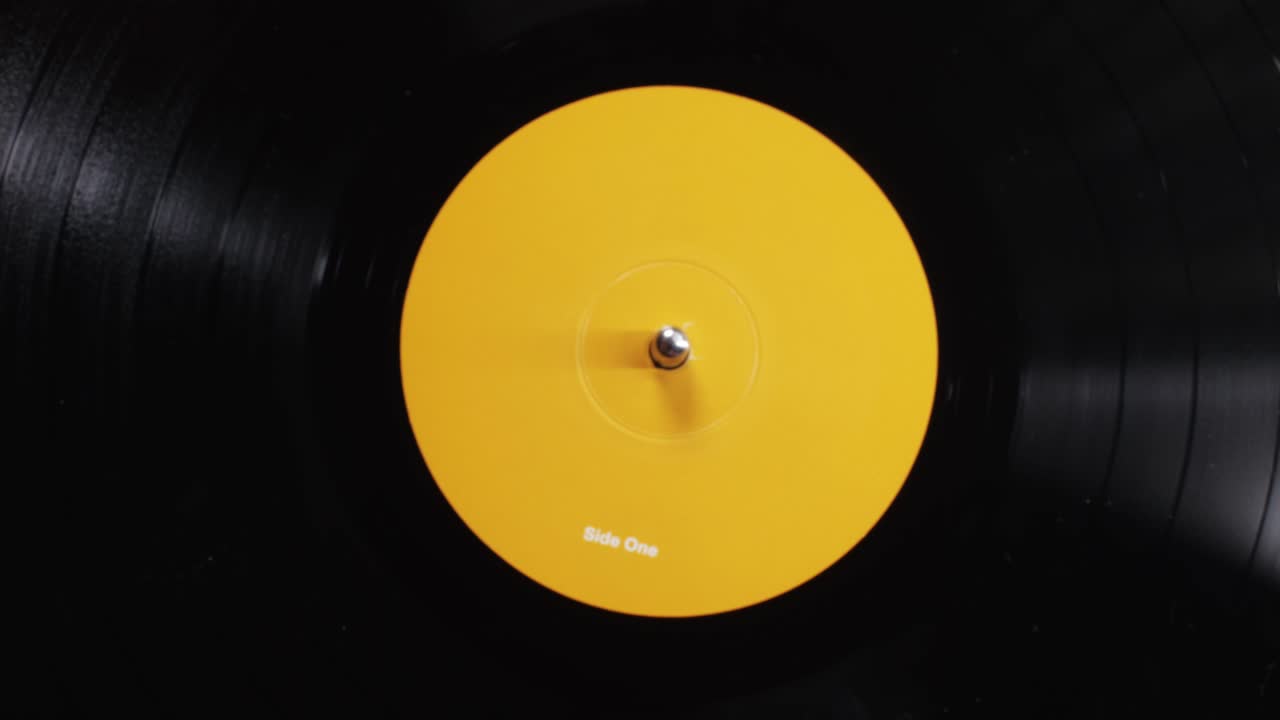 Retro Vinyl record player playing music, close-up macro shot of vintage LP disc old phonograph spinning. Retro music player.