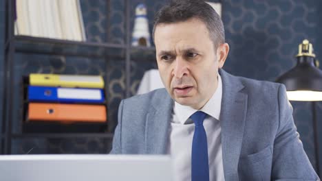 Focused-businessman-reads-news-on-laptop-with-amazement-and-amazement-with-interest-and-attention.