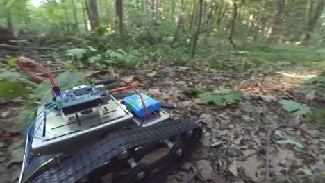 rc robot tank driving through the forest