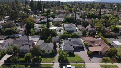 luxury homes in the tarzana and woodland hills neighborhood of los angeles, rising drone shot.