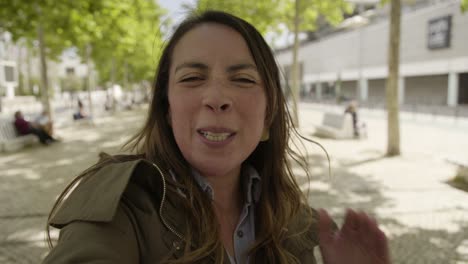 smiling young woman talking to camera.