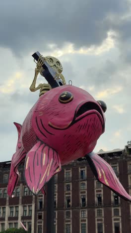 giant skeleton riding a colorful fish in mexico city for day of the dead celebrations