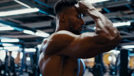 man drinking a sports drink in gym