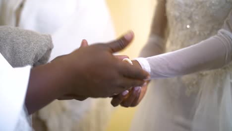 mother fixing jewelry on brides hands on wedding day