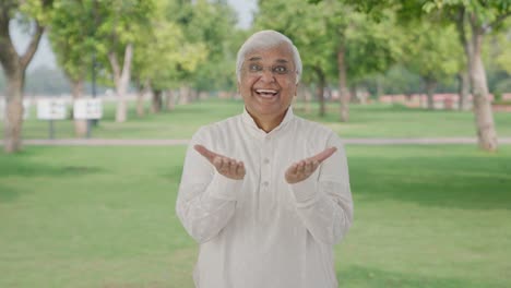 Happy-Indian-old-man-getting-a-big-surprise-in-park