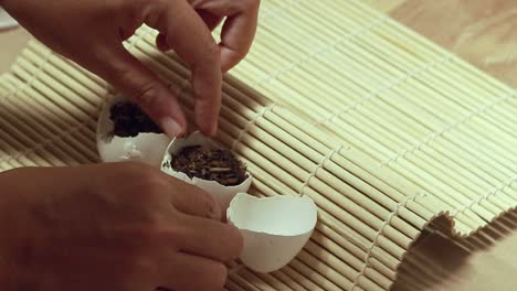 filling eggshells with soil mix to create an organic seed starter container, creative eco-friendly gardening idea for a sustainable lifestyle