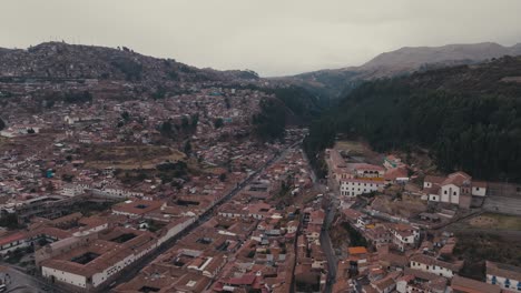 old cityscape surrounded by mountains in cusco, peru. aerial drone shot