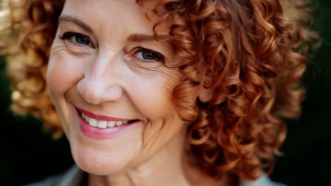 smiling woman with curly red hair