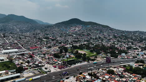 aerial view over a road approaching a face in the hills of ecatepec de morelos, mexico