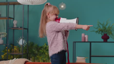 Child-girl-kid-standing-on-sofa-at-home-alone-loudly-shout-in-megaphone-announces-discounts-sale