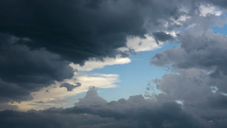 clouds full of texture and colour moving across blue skies