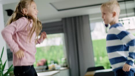 Handheld-view-of-happy-children-jumping-on-the-bed