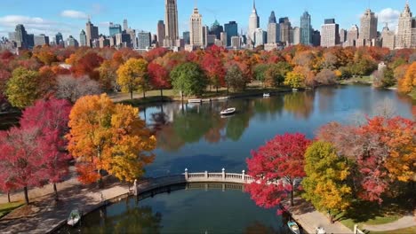new york city central park in vibrant autumn colors and skyline