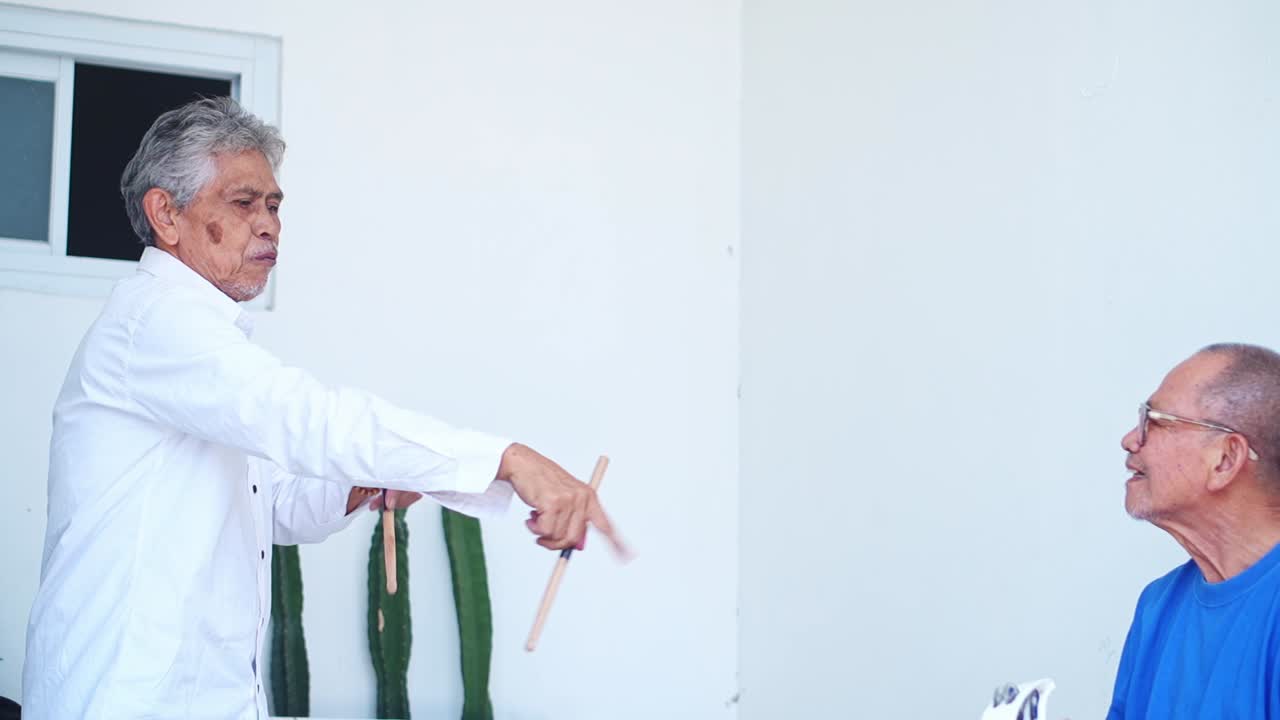 Joyful seniors enjoying togetherness while playing music at terrace