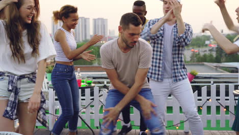 friends dancing on a rooftop