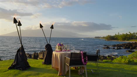 romantic table for two overlooking the sea and sunset, maui hawaii - push in and slow motion